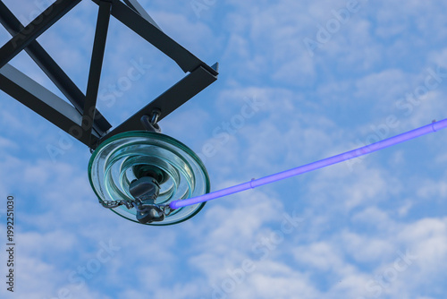 A blue light is shining on a glass object