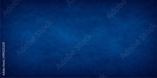 Dark blue grunge paper texture background with a vintage rough wall pattern and purple art accents on a dirty canvas surface design providing copy space