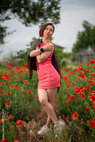 Woman in Pink Dress Posing in Poppy Field