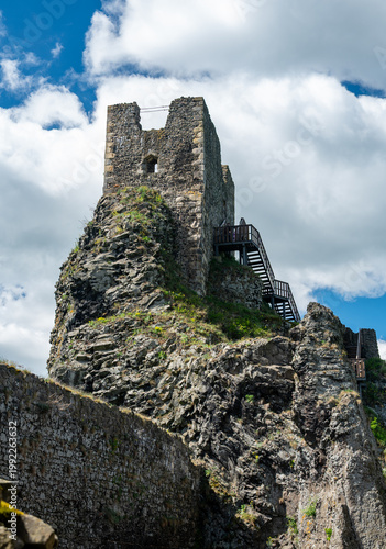Close up view of the walls and iconic towers of Trosky Castle in Cesky Raj Czech Republic with massive stone structures rising above ruins in summer weather popular tourist destination