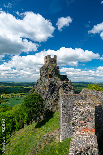 Close up view of the walls and iconic towers of Trosky Castle in Cesky Raj Czech Republic with massive stone structures rising above ruins in summer weather popular tourist destination