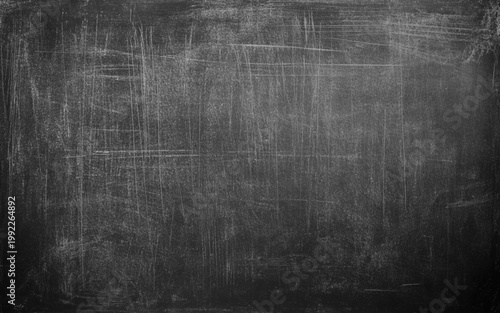 School blackboard background with erased chalk stains and dramatic lighting. Blackboard texture background
