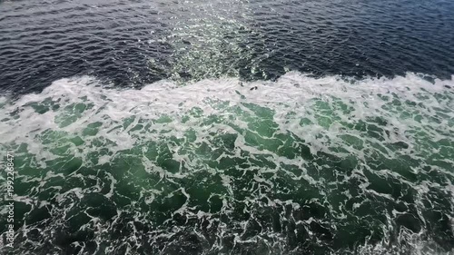 August 13, 2024 - Tracy Arm, USA - Water surface showing patterns of waves and boat motion created by a ship traveling through Tracy Arm fjord system in Alaska.