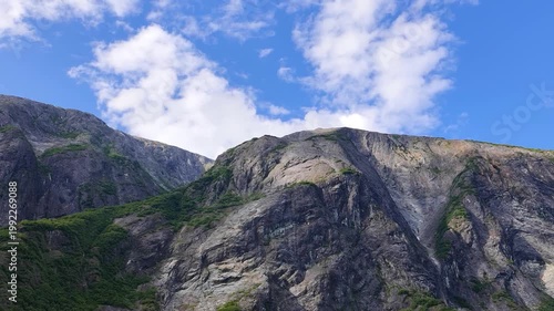 August 13, 2024 - Tracy Arm, USA - The shot shows the impressive rocky mountains with glaciers as well as a body of water in a remote area in Tracy Arm wilderness.