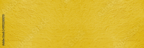Bild auf Leinwand Background of natural yellow gold golden stucco in plaster cement texture lined pattern or stone in colors aged Textured illuminated wall fence surface blend of warm sunny tones backdrop