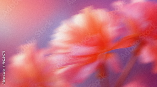 Floral motion blur featuring soft pink and orange flowers against a gradient background with subtle hues of purple and blue creating an abstract, dreamy effect