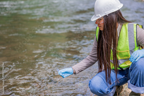 copyspace Latin environmental engineer sampling river water for pollution
