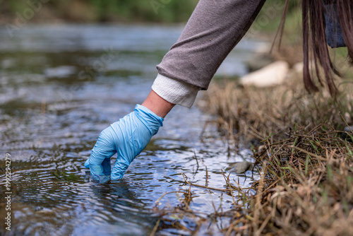 Environmental engineer checking water quality in river