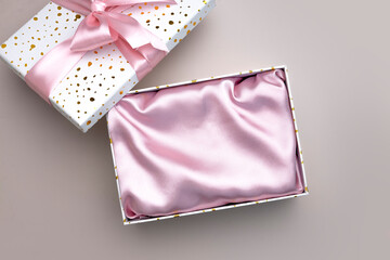 Pink decorated with satin cloth opened empty box top view,cosmetics and beauty advertisement template. Product display, placement.Showcase. Mother's day blank.