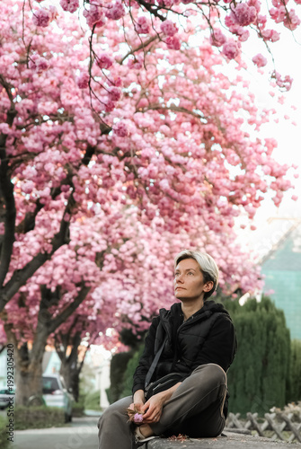 woman Spring flowers sakura garden background pink