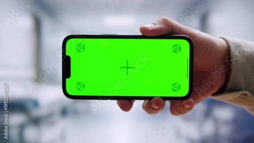 Doctor using smartphone phone or tablet with chroma key, medical professional, telemedicine, online consultation, healthcare communication, digital health, technology in medicine, patient care.