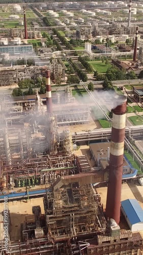 Aerial View of a Large Petrochemical Refinery Complex with Smoking Chimneys