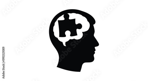 A dark silhouette of a human head contains a white puzzle piece representing thought and problem solving silhouette