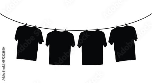 Four t shirts hanging on a line shown as a dark silhouette