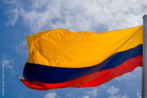 Colombia flag waving in a blue cloudy sky