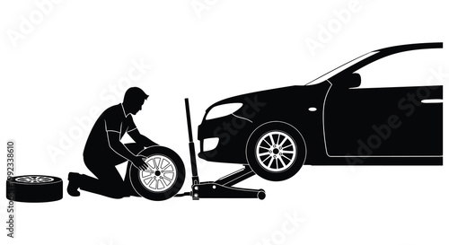 A man changes a car tire on the roadside utilizing a jack and spare wheel a striking silhouette high quality