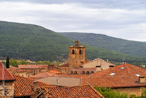 Fotografie Vinuesa village church tower with traditional spanish rooftops