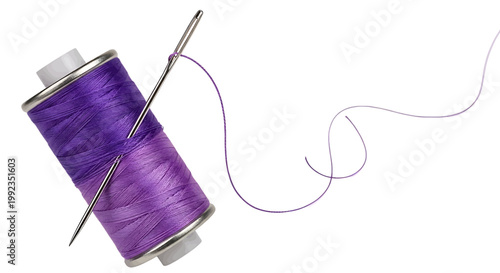Purple sewing thread spool with a needle