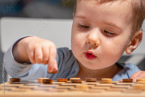 Child exploring simple game, symbol of early childhood education.