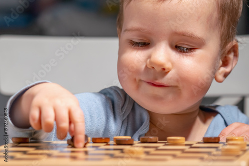 Child concentrating on game pieces, concept of logic and intelligence.