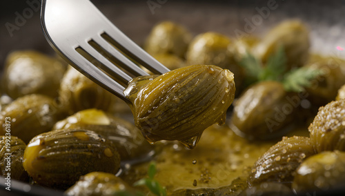 Close-up of a fork lifting a green pickled olive from a dish with sauce and herbs with green olives with olive oil with mediterranean food with table food with snack time with food photography