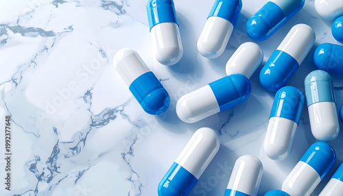 Blue and white medical capsules on a bright marble surface. Represents healthcare, pharmacy, treatment, or pharmaceutical science. Clean background with copy space