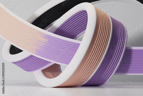 A close-up view of colorful ribbons in various shades of purple, pink, and black, arranged in a creative and artistic way.