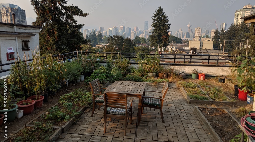Naklejka premium Rooftop urban garden with wooden table and chairs overlooking city skyline at sunset, outdoor terrace with vegetable beds and relaxing seating area
