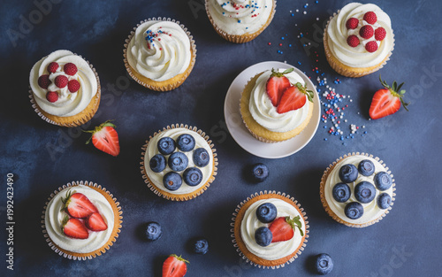 Patriotic Cupcakes with Berries on Dark Blue Background Top View Festive Dessert Concept
