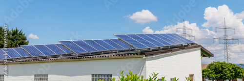 Fotografie Installation of solar panels on rooftops in a sunny location during daytime hour