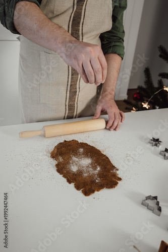 Man cooking homemade cookies for christmas at home.