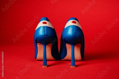 heels with blood stained bandages on a red background