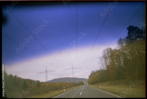 View from a moving car across the country road