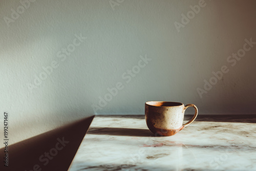 simple wooden bench positioned near window radiates warmth from softly glowing candle
