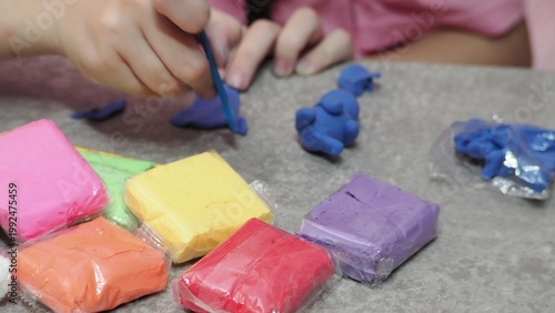 Little girls sculpt figurines crafts from air plasticine, modeling dough. Online lessons in tablet. Children's creativity hobby developing activities, training, learn of fine motor skills of hands.