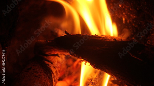 Fire burning in a fireplace, wood logs and flames. Warm home, heat