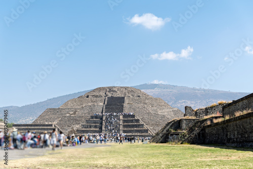 Visitors explore the Pyramid of the Moon at Teotihuacan site in Mexico under a clear sky