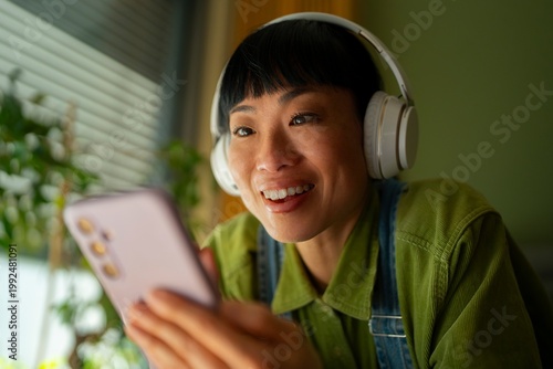 Happy woman listens to music on phone