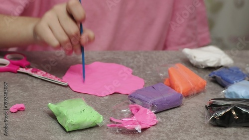 Little girls sculpt figurines crafts from air plasticine, modeling dough. Online lessons in tablet. Children's creativity hobby developing activities, training, learn of fine motor skills of hands.