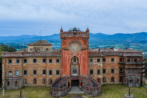 Aerial view of the Moorish Revival facade of Castello di Sammezzano with its iconic clock tower and grand staircase in Reggello, Tuscany, Italy.