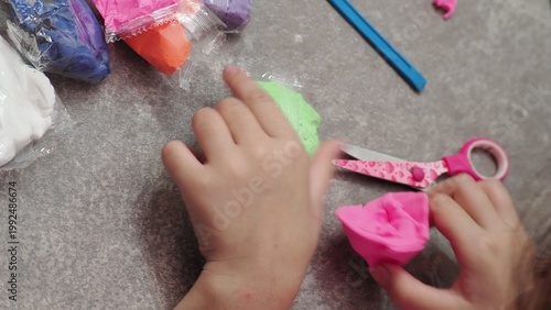 Little girls sculpt figurines crafts from air plasticine, modeling dough. Online lessons in tablet. Children's creativity hobby developing activities, training, learn of fine motor skills of hands.
