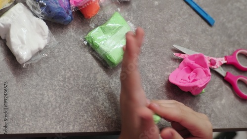 Little girls sculpt figurines crafts from air plasticine, modeling dough. Online lessons in tablet. Children's creativity hobby developing activities, training, learn of fine motor skills of hands.