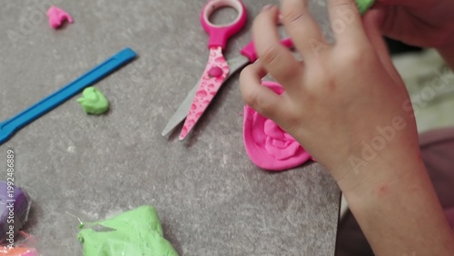 Little girls sculpt figurines crafts from air plasticine, modeling dough. Online lessons in tablet. Children's creativity hobby developing activities, training, learn of fine motor skills of hands.