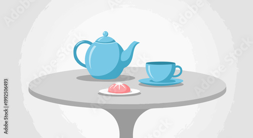 Blue teapot with matching cup and sweet dessert on a round table.