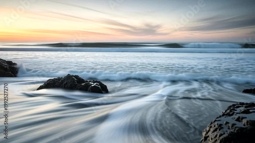 Serene Beach Scene at Sunset with Rocks.