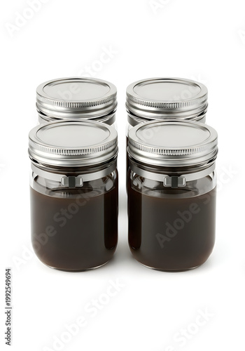 Four small jars of dark jam or jelly