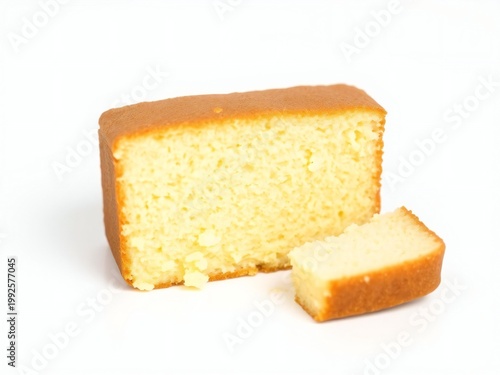 A slice of moist yellow cake with a light golden-brown crust on top
