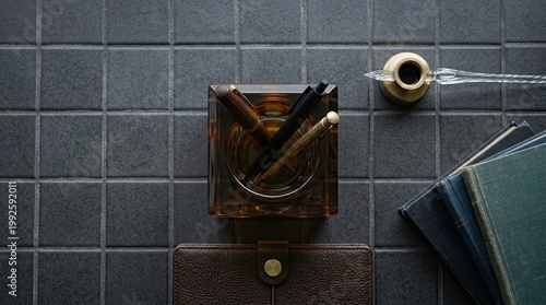 Stylish Desk Setup with Pens and Books on Dark Surface