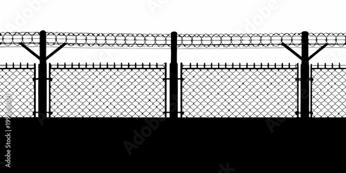 A stark silhouette of a chain link fence with barbed wire atop