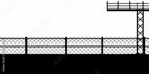 Black and white silhouette of a barbed wire fence and watchtower